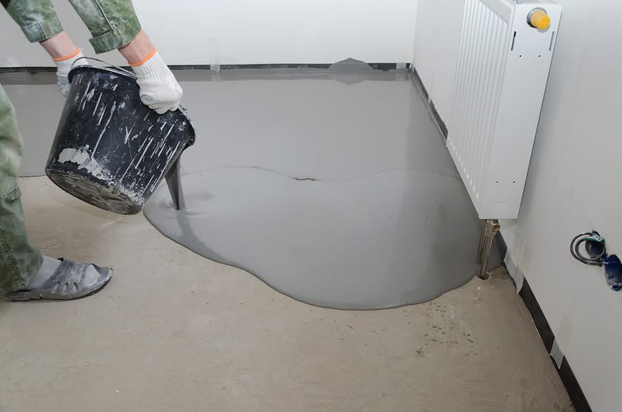 worker pouring epoxy in the floor