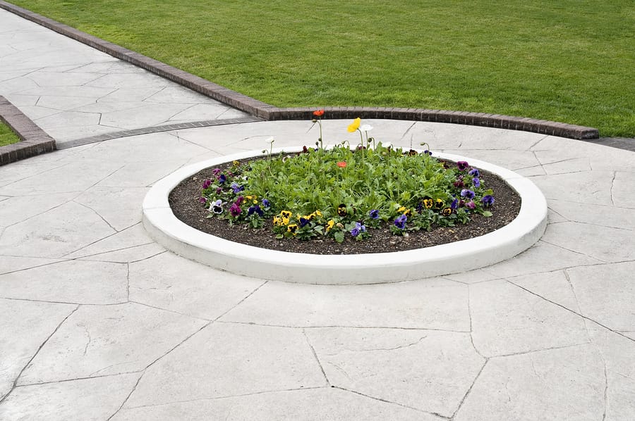 landscaping showing walkway flower bed and green lawn