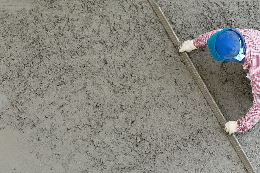 worker scraping the cement